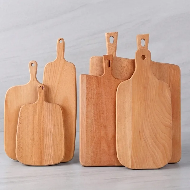 Six assorted beech wood cutting boards with handles standing upright