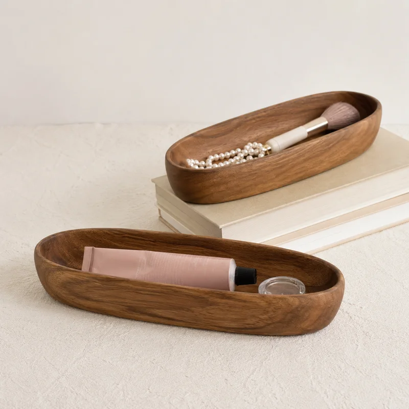 Front view of boat-shaped wooden valet tray