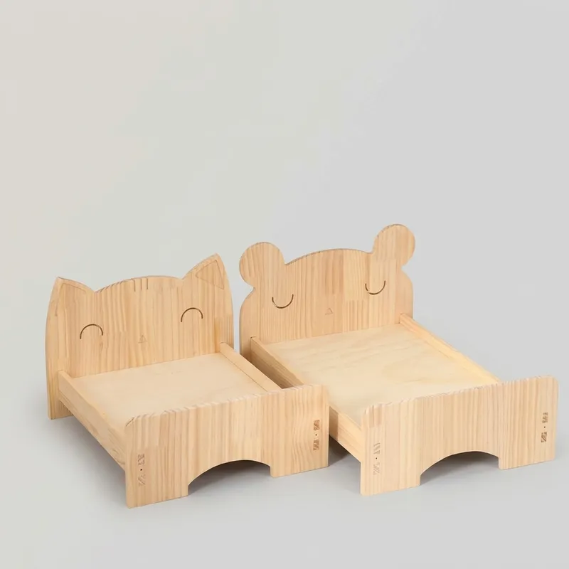 Two cartoon wooden pet beds with cat and bear headboards