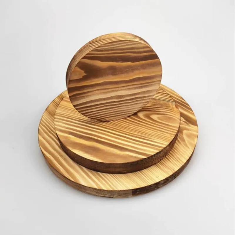 Three stacked round pine wood slices with distinct dark grain lines