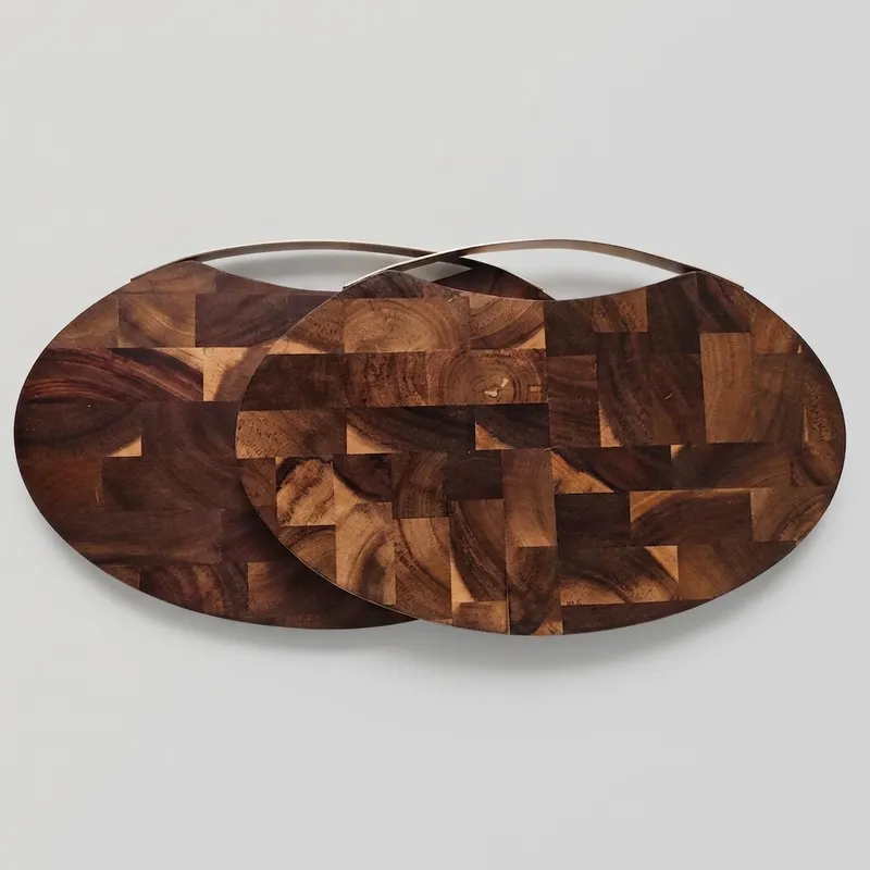 Two oval checkered acacia wood chopping boards with stainless steel handles