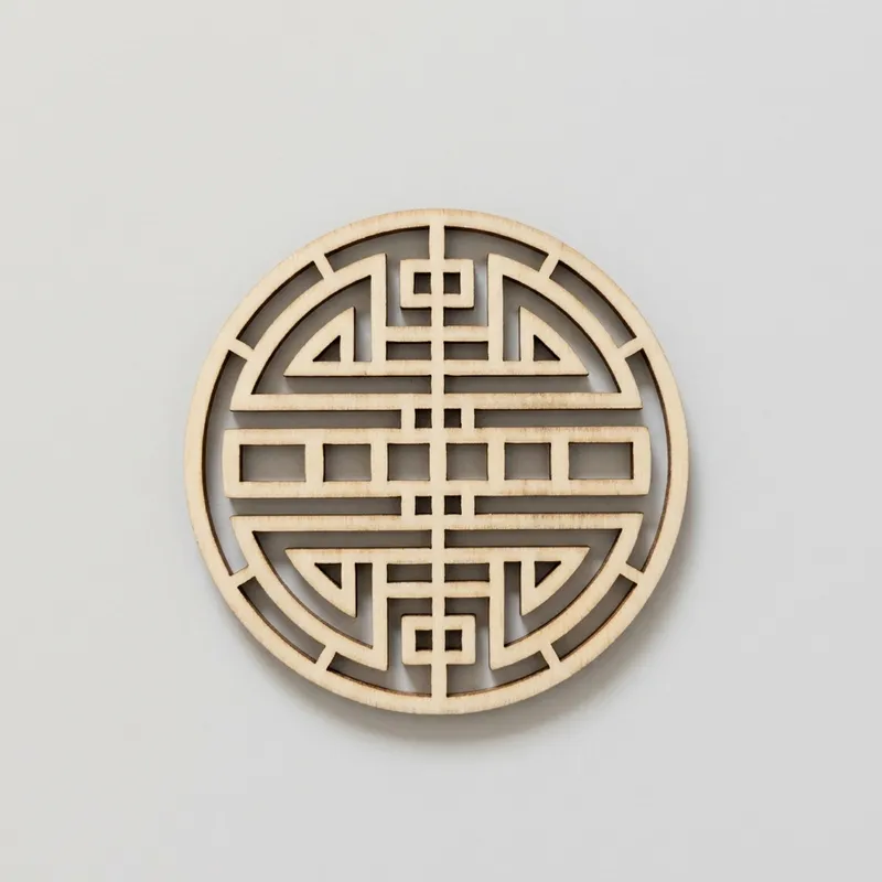 An unfinished round wood slice with a traditional geometric lattice design.