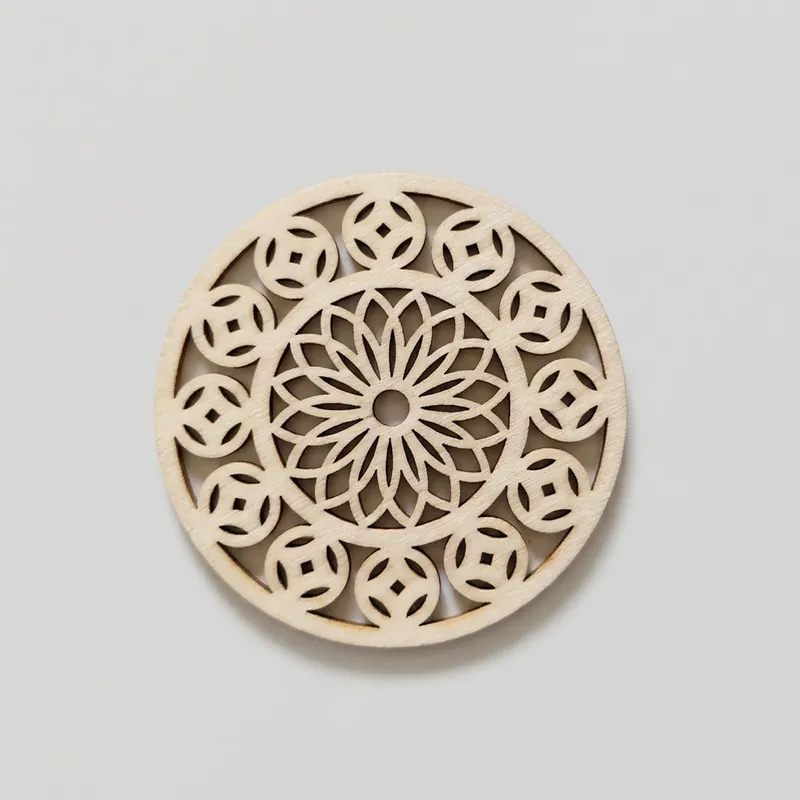 A circular wood craft cutout showing a flower center with small outer circles.
