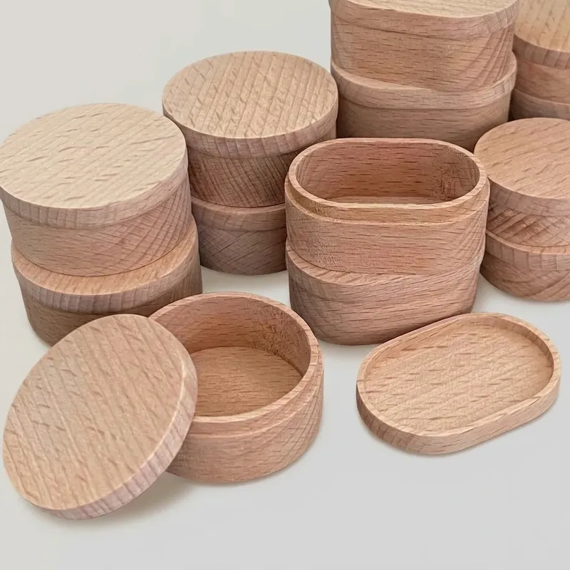 Open and closed miniature wooden boxes displaying natural wood grain