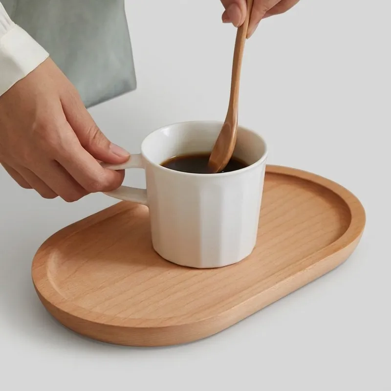 Dark brown ebony wood oval tray with rich grain pattern