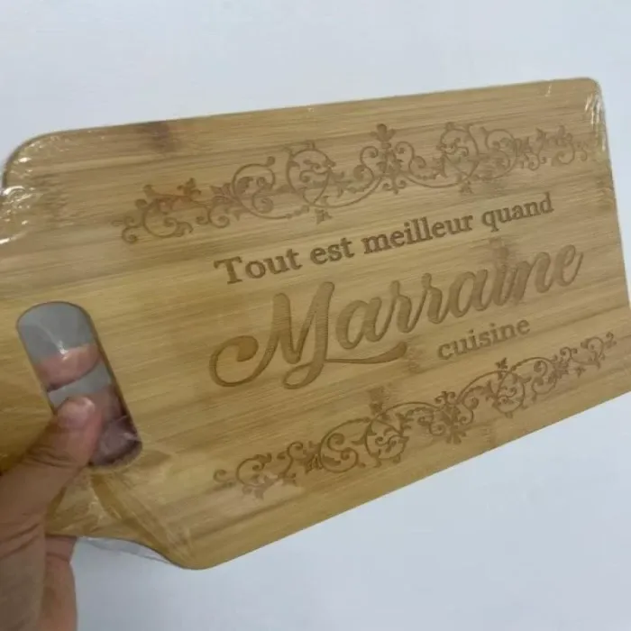 Close up of laser engraved bamboo cutting board with decorative text