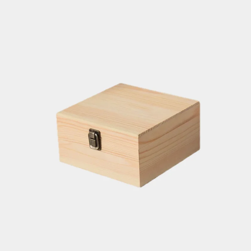 Closed square pine wood box with metal clasp on white background