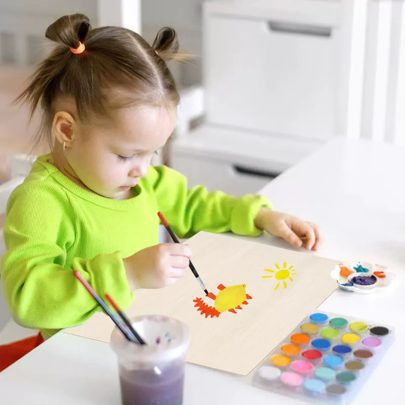 Young girl painting colorful designs on a flat wood piece