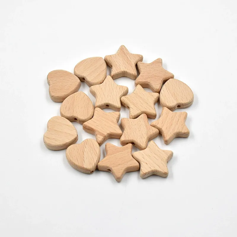 A scattered pile of natural beech wood star and heart shaped beads