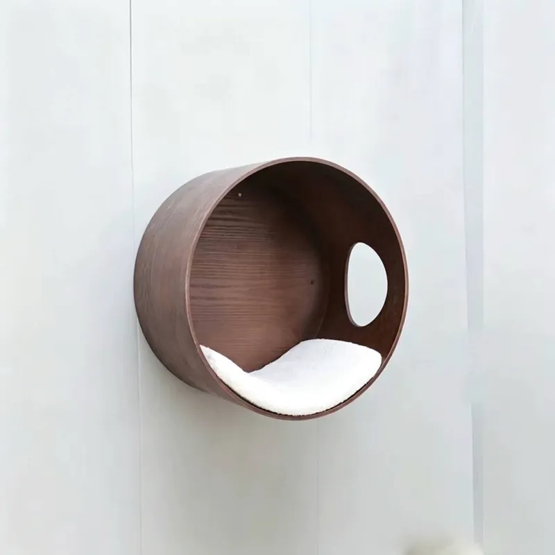Wall-mounted cylindrical cat nest in walnut color with white cushion