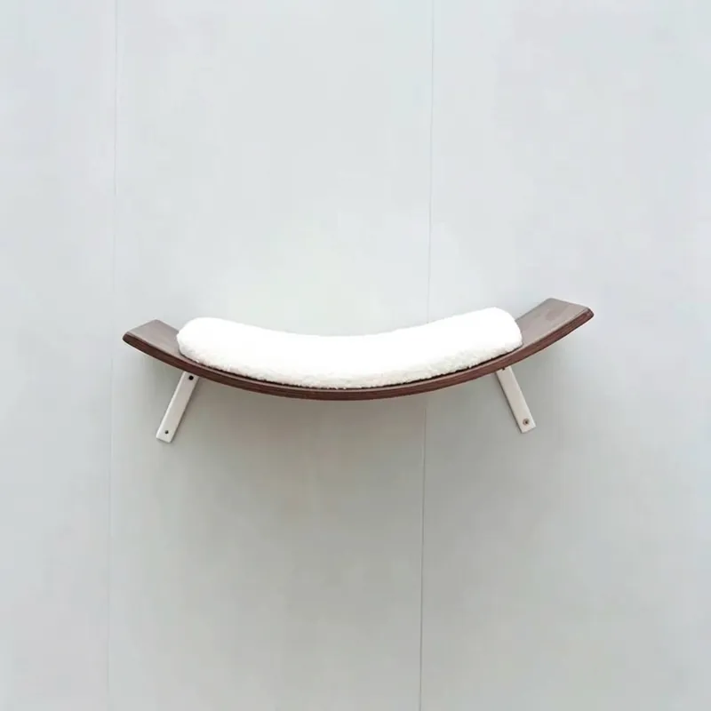 Curved wall-mounted walnut cat perch with white metal brackets and cushion