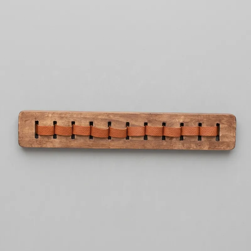 Factual front view of rectangular brown wooden rack with leather loops