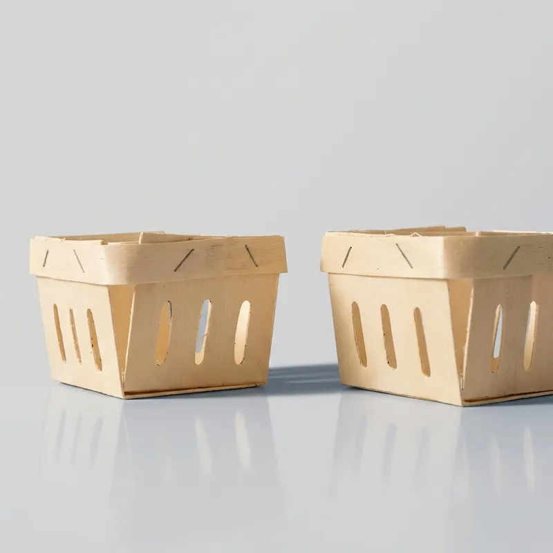 Two square open-top wood veneer storage baskets on a reflective surface